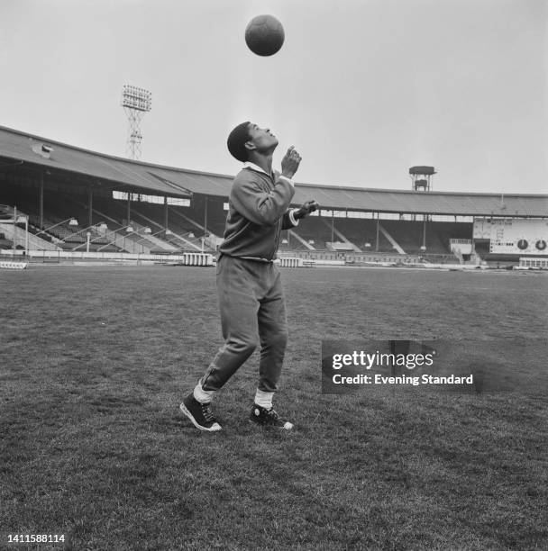 Portuguese footballer Eusebio , Benfica striker, heading the ball during a training session ahead of the European Cup semi final second leg match...