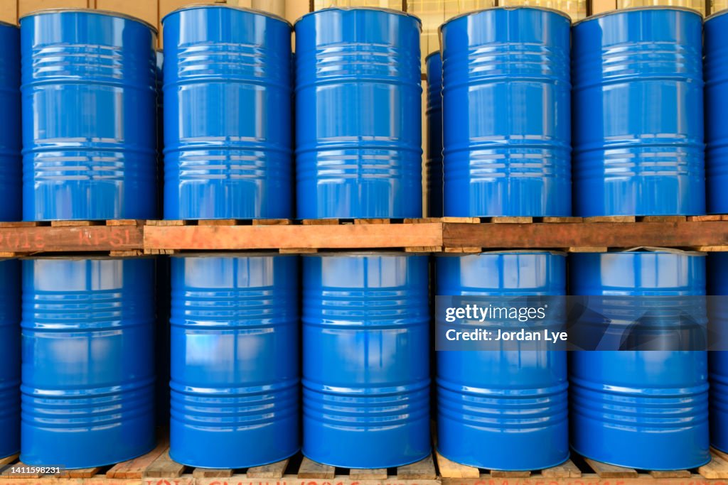 Blue Metal Oil Barrels Stacked In A Drumming Room