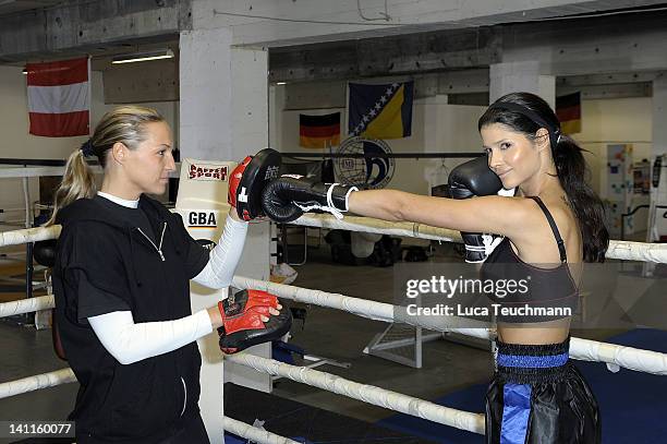 Model Micaela Schaefer and Ramona Kuehne train for a tv celebrity boxing show at the Box Gym Koepenick on March 11, 2012 in Berlin, Germany.