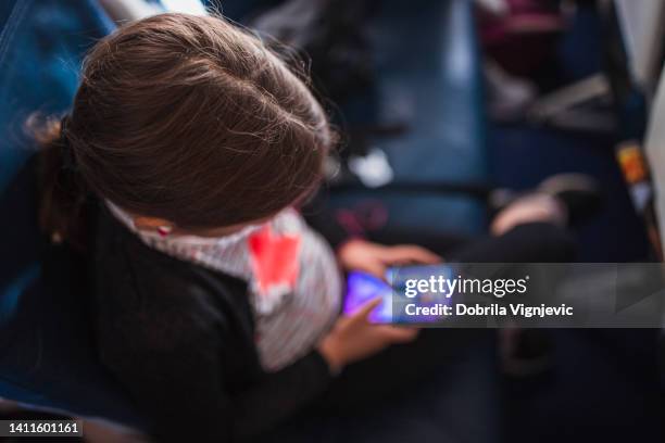 aerial view of teenage girl using phone at airplane - watching youtube stock pictures, royalty-free photos & images