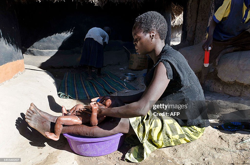 Ugandan Margareta Otto, 26, washes on Fe