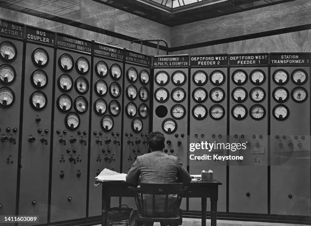 Man monitoring various dials and meters in a control room at the newly-built Battersea Power Station, London, 6th September1932.