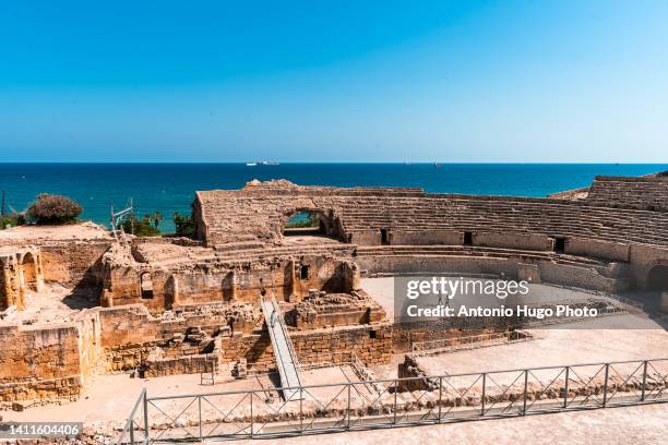 roman amphitheater of tarragona and coast in the background. - tarragona stock pictures, royalty-free photos & images