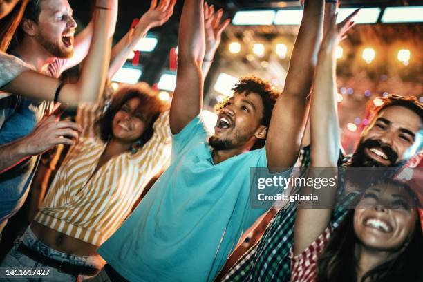 young people dancing at a concert. - party atmosphere stock pictures, royalty-free photos & images