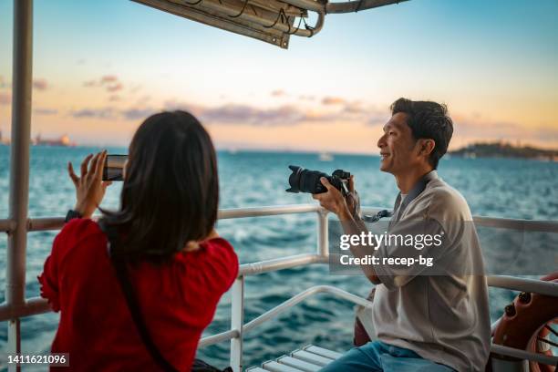 young couple tourists taking ferry tour during their travel - asian tourist bildbanksfoton och bilder