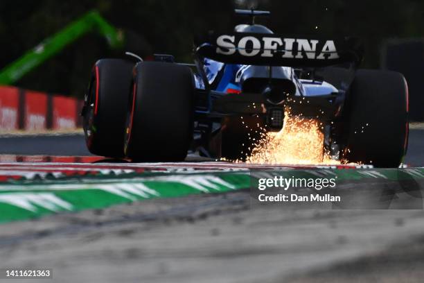 Sparks fly behind Alexander Albon of Thailand driving the Williams FW44 Mercedes during practice ahead of the F1 Grand Prix of Hungary at Hungaroring...