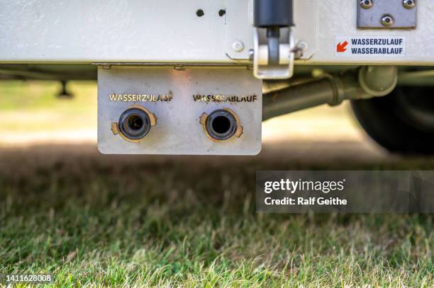 Detailed recording of the water supply of a caravan with the words water inlet and water outlet in German language