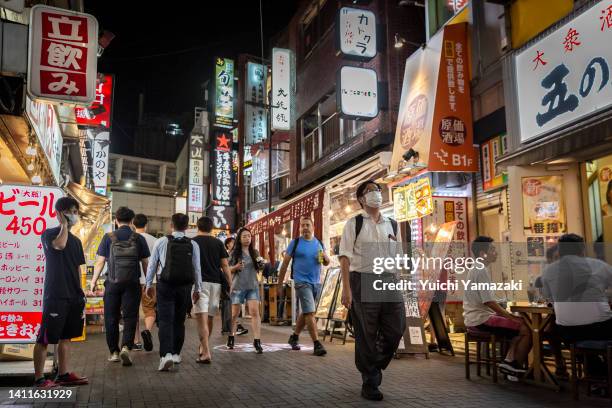 People walk through Ueno area on July 29, 2022 in Tokyo, Japan. World Health Organization announced Japan's COVID-19 cases between July 18 to 24...