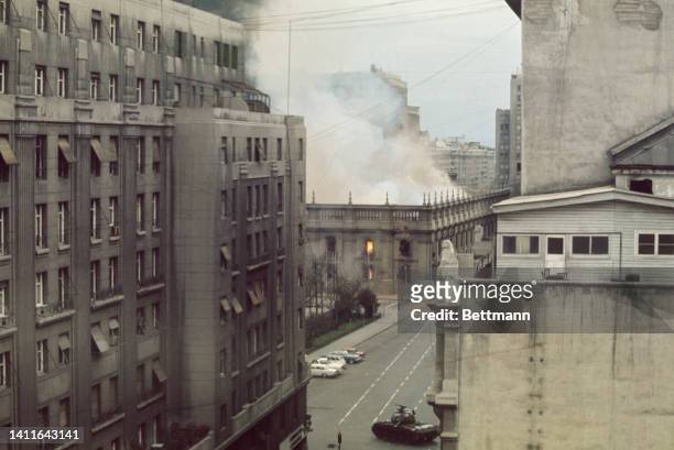 Presidential Palace, La Moneda, in flames as tanks fire at point blank range as it was bombed by jets as the three armed forces and national poloce...