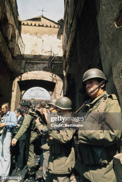 Chilean soldiers entering the wreckage of La Monedo during a press tour.