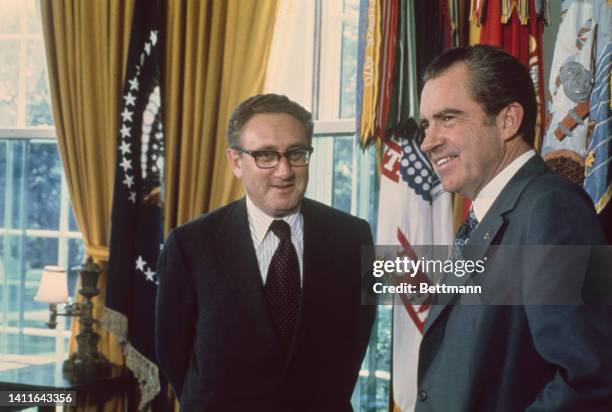 President Richard Nixon congragulates Secy of State Henry Kissinger at the White House after it was announced that Kissinger and North Vietnam's Le...