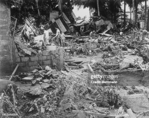 Searchers go through debris at Humacao after the winds of Hurricane Donna lashed Puerto Rico's southeastern coastal region. The storm appeared to be...