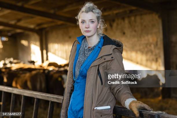 female farming apprentice portrait - agricultural building stock pictures, royalty-free photos & images