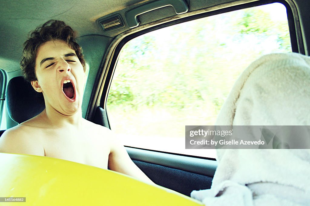 Boy yawning in car