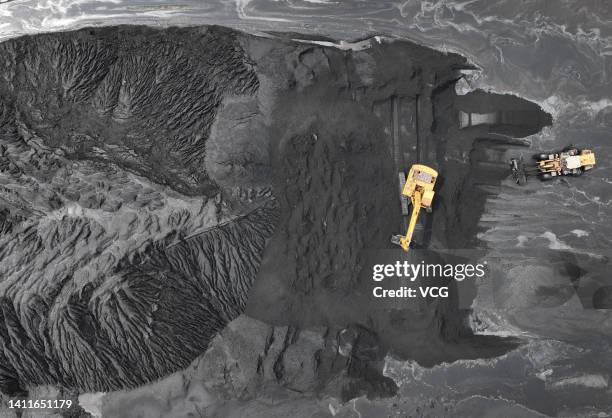 Excavators pile coal at Lianyungang Port on July 29, 2022 in Lianyungang, Jiangsu Province of China.