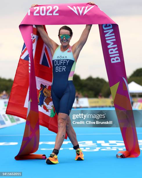 Flora Duffy of Team Bermuda celebrates after crossing the finish line during the Women's Individual Sprint Distance Triathlon Final on day one of the...