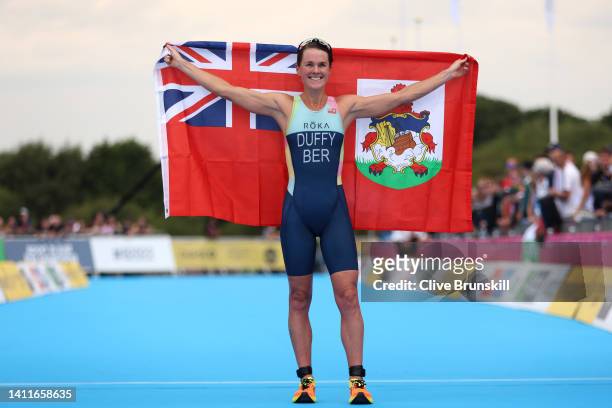Flora Duffy of Team Bermuda celebrates after crossing the finish line during the Women's Individual Sprint Distance Triathlon Final on day one of the...
