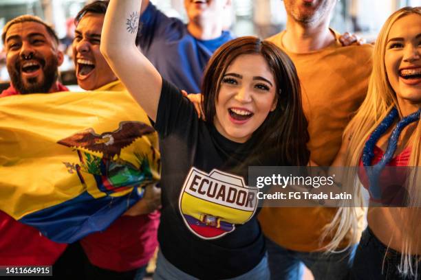 ecuadorian fans watching a soccer game and celebrating at bar - ecuadorian ethnicity stock pictures, royalty-free photos & images