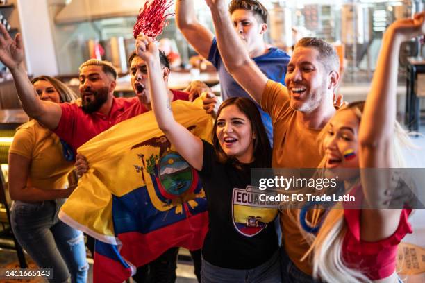 ecuadorian fans watching a soccer game and celebrating at bar - ecuadorian ethnicity stock pictures, royalty-free photos & images