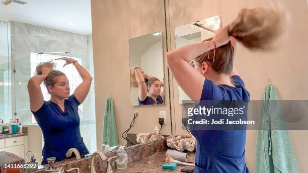 nurse in scrubs getting ready for work - multitasking nurse stock pictures, royalty-free photos & images