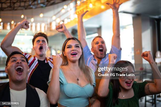 friends watching and celebrating a sport match - american football game bildbanksfoton och bilder