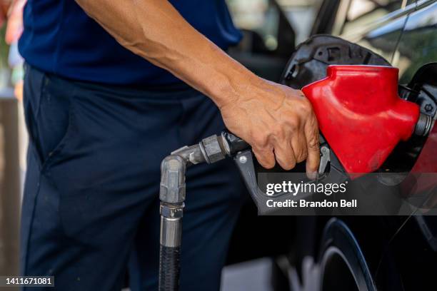 Customer pumps gas at an Exxon gas station on July 29, 2022 in Houston, Texas. Exxon and Chevron posted record high earnings during the second...