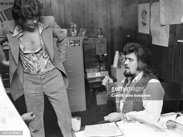 American disc jockey and radio personality Wolfman Jack meets backstage with promoters before he emcees an event at Uncle Sam's nightclub in Macon,...