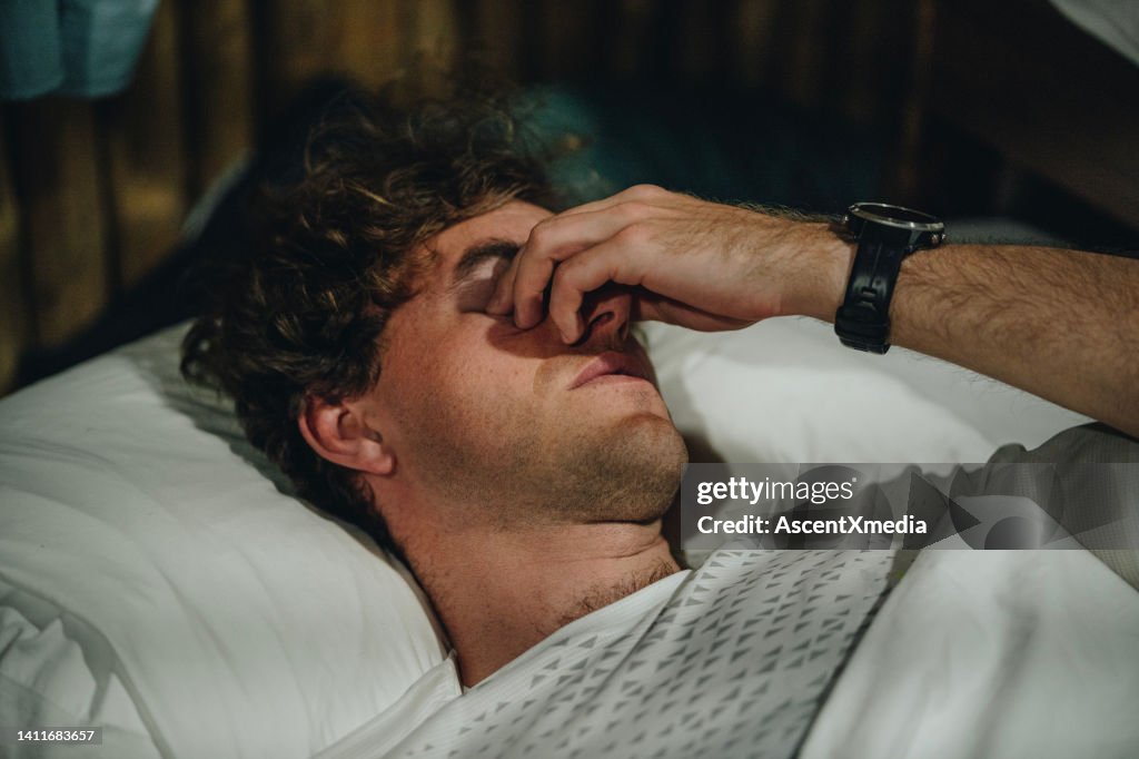 Portrait of young man waking up in the morning