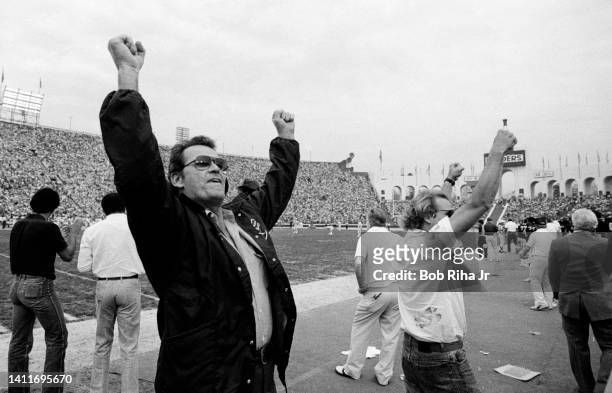 Actor James Garner cheers the Raiders and fans from field during AFC Playoff game, January 15, 1983 in Los Angeles, California.