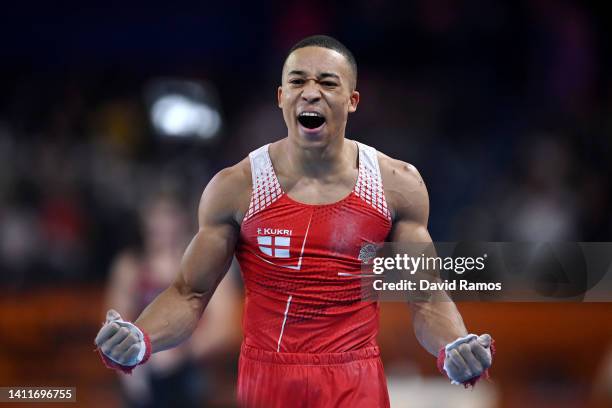 Joe Fraser of Team England celebrates after their routine on horizontal bar during the Men's Team Final and Individual Artistic Gymnastic...