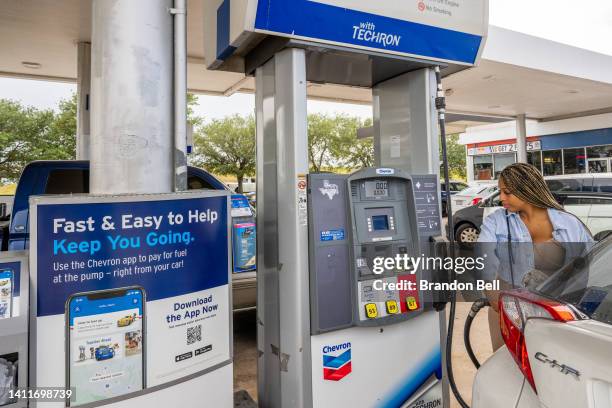 Customer prepares to pump gas at a Chevron gas station on July 29, 2022 in Houston, Texas. Exxon and Chevron posted record high earnings during the...