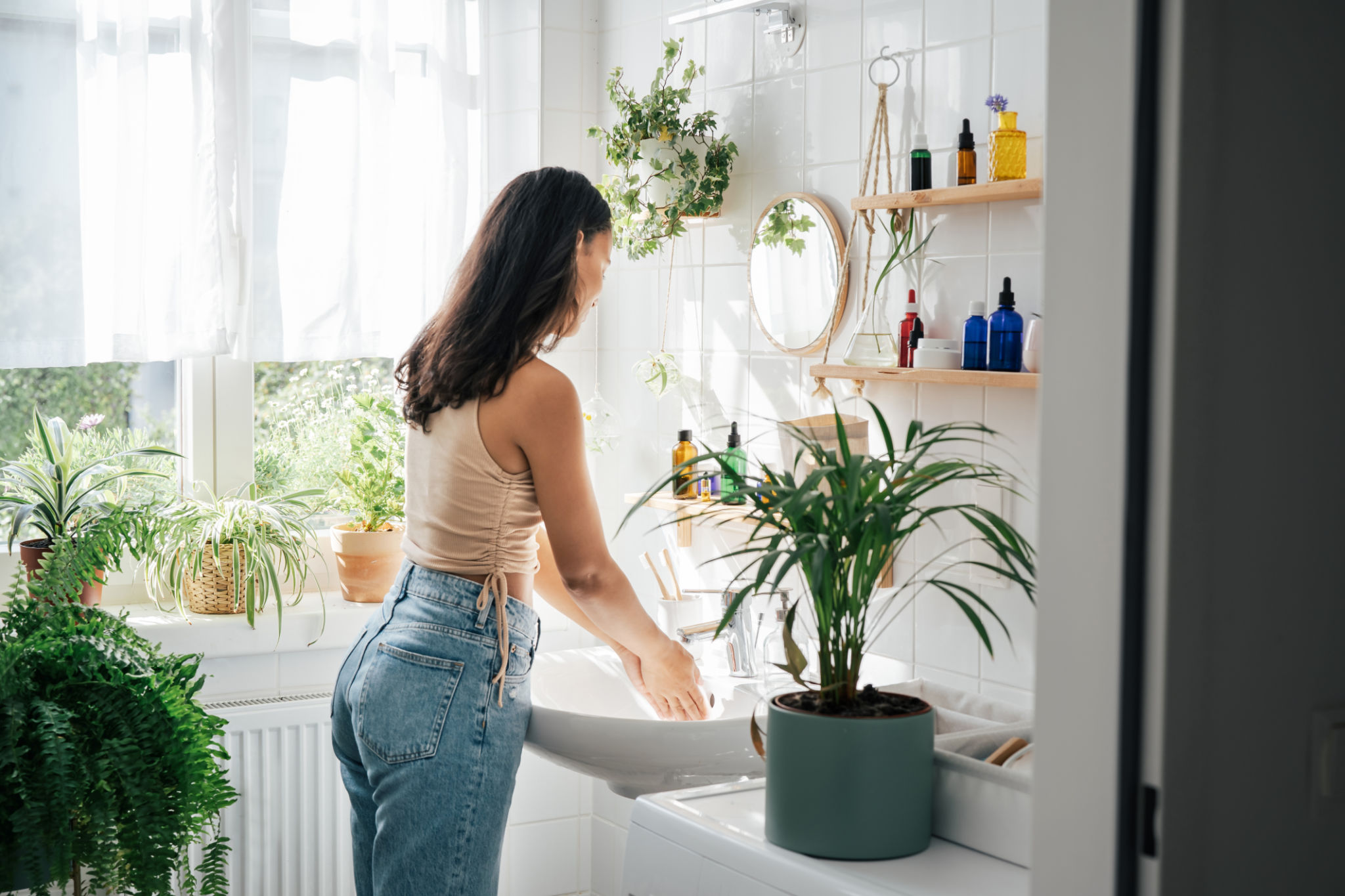 Young beautiful woman with dark skin washing hands Young beautiful woman with dark skin washing hands