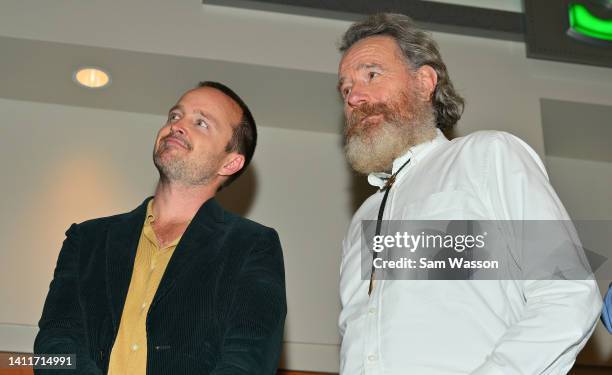 Actor Aaron Paul and actor Bryan Cranston look on during an unveiling ceremony of bronze statues depicting television characters Walter White, played...