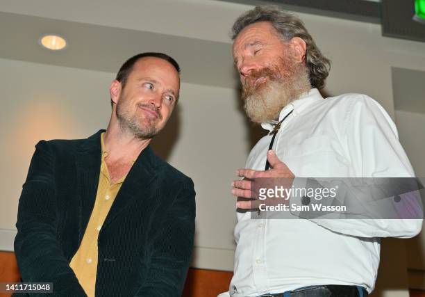 Actor Aaron Paul and actor Bryan Cranston react during an unveiling ceremony of bronze statues depicting television characters Walter White, played...