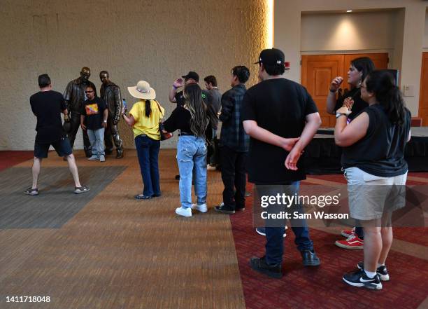 ALBUQUERQUE, NEW MEXICO Fans take photos with bronze statues depicting television characters Walter White, played by actor Bryan Cranston, and Jesse...