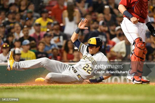 Christian Yelich of the Milwaukee Brewers slides safely into home to score a run against the Boston Red Sox during the sixth inning at Fenway Park on...