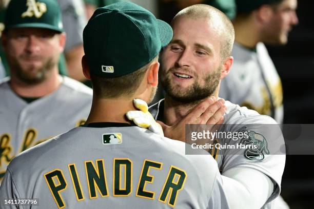 Chad Pinder and Seth Brown of the Oakland Athletics celebrate in the dugout after the home run in the sixth inning against the Chicago White Sox at...