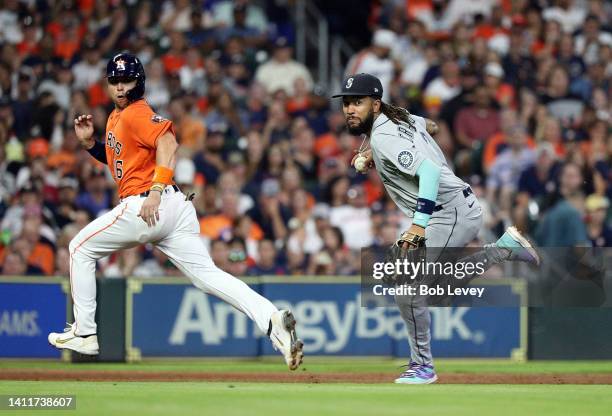 Crawford of the Seattle Mariners attempts to tag Aledmys Diaz of the Houston Astros as he throws out Jose Altuve in the fifth inning at Minute Maid...