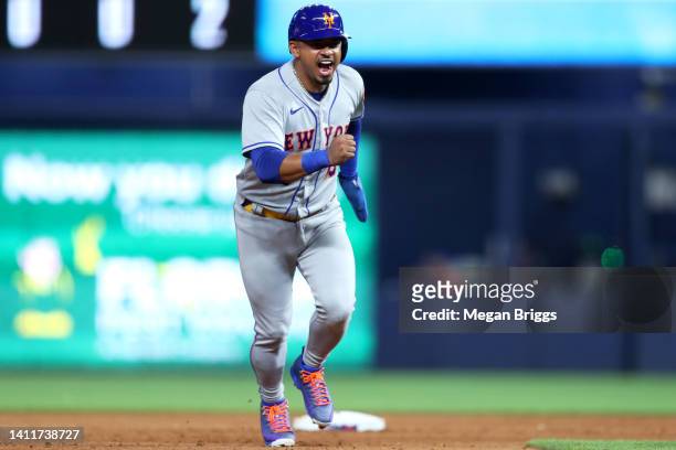Eduardo Escobar of the New York Mets reacts after Brandon Nimmo of the New York Mets hit a home run during the eighth inning against the Miami...
