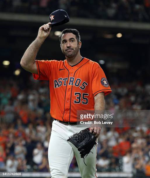 Justin Verlander of the Houston Astros tips his hat to the crowd as he leaves in the eighth inning against the Seattle Mariners at Minute Maid Park...
