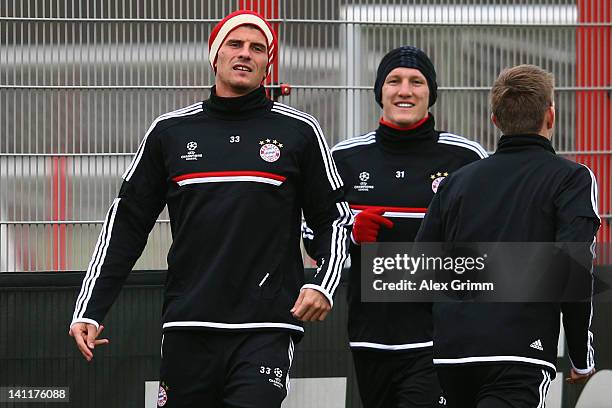 Mario Gomez and Bastian Schweinsteiger attend a Bayern Muenchen training session ahead of their UEFA Champions League Round of 16 second leg match...