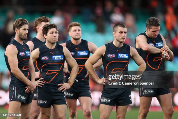 Callan Ward, Toby Greene of the Giants and team mates look dejcted after losing the round 20 AFL match between the Sydney Swans and the Greater...