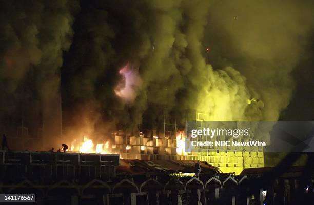 Pictured: The outside of the Marriott Hotel burning, while people are still inside, after a dump truck filled with explosives detonated during a...