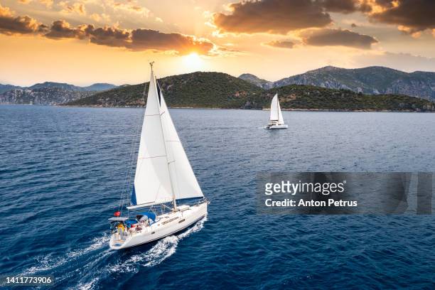 yacht with white sails at sea at sunset. luxury vacation at sea, yachting in croatia. - sail stockfoto's en -beelden