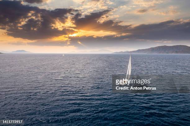 yacht in the open sea at sunset. yachting, luxury vacation at sea - sailing stock pictures, royalty-free photos & images