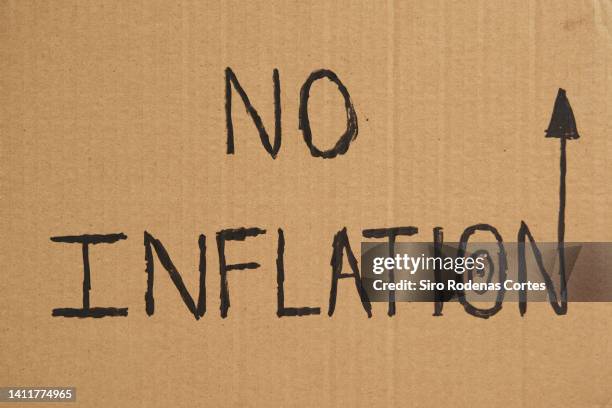 close-up of message on a cardboard at a protest against economic inflation - economic cartel stock pictures, royalty-free photos & images