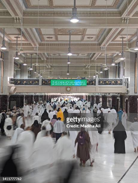 pilgrims doing saee or saii between safa and marwa mounts near khaana kaaba in holy mosque of al haram during hajj and umrah | motion of people wearing ihram for haj and umra, mecca, saudi arabia - mecca stock pictures, royalty-free photos & images