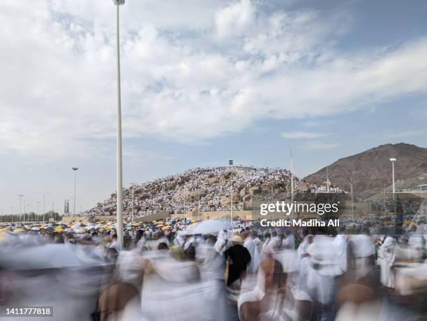 people standing on mount arafat during the day of  arafah during hajj | holy mosque of al haram while pilgrims doing tawaaf  of kaba for hajj and umrah | motion of people wearing ihram for haj and umra, mecca, saudi arabia | jabal rahmah - kaba at mecca stock pictures, royalty-free photos & images