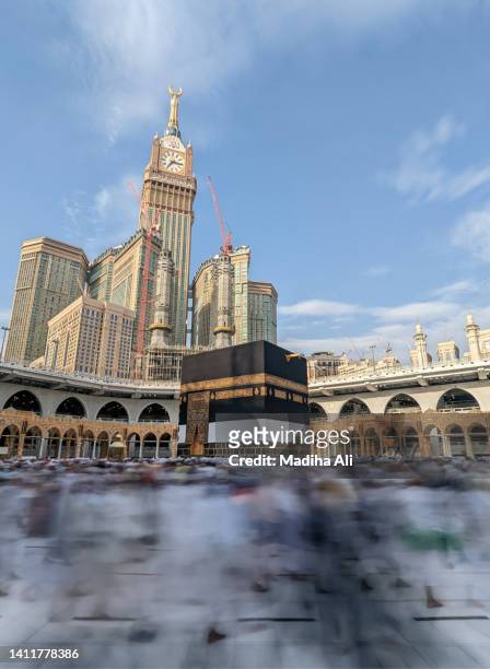 pilgrims doing tawaaf of khaana kaaba in holy mosque of al haram for hajj and umrah | motion of people wearing ihram for haj and umra, mecca, saudi arabia - mecca stock pictures, royalty-free photos & images