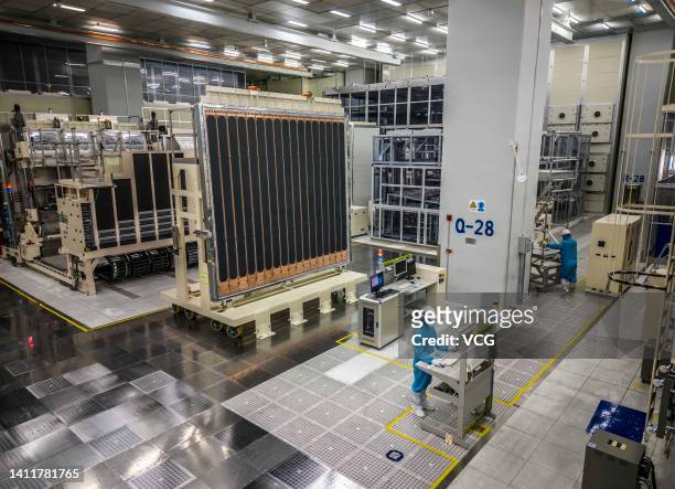 An employee works on the 10.5-generation production line of glass substrate production at a factory of BOE Technology Group Co. Ltd on July 28, 2022...